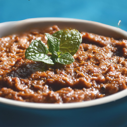 Pudina thokku served with hot rice and ghee on banana leaf plate